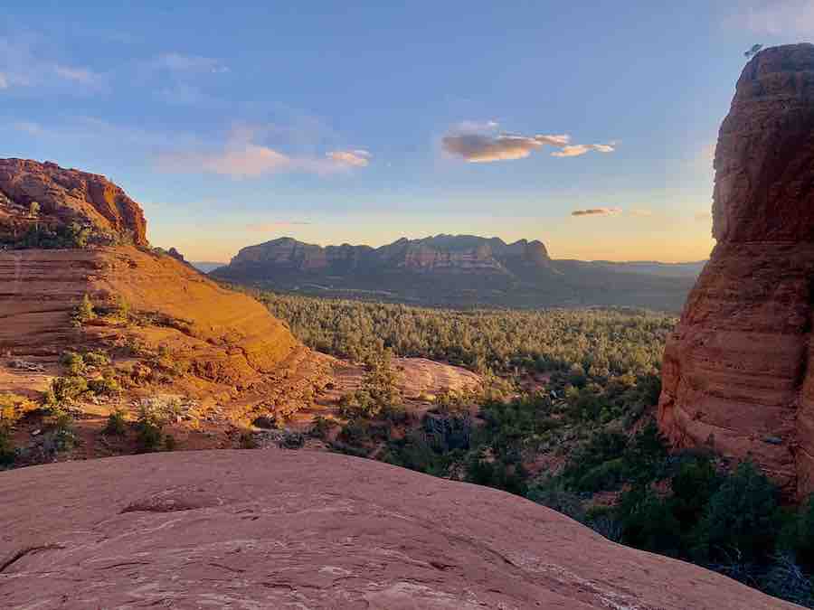 sunset view of Sedona red rocks with red rock in the foreground