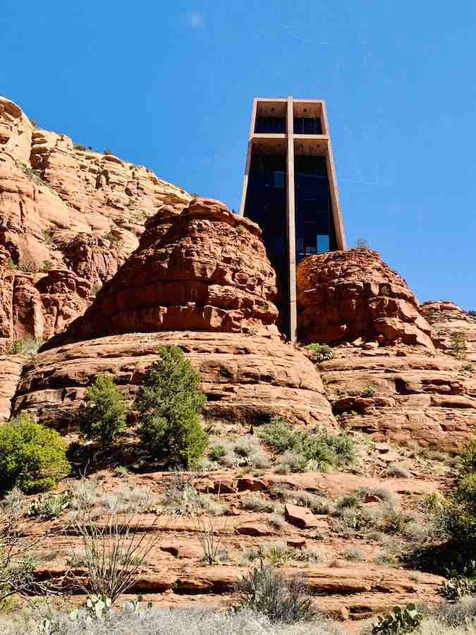 Chapel of the Holy Cross, built into the red rock, with a large cross along the entire face of the building and going into the rock as an important structural piece