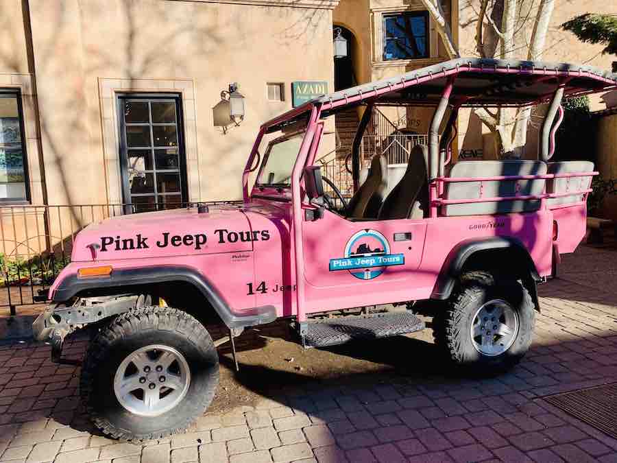 Pink Jeep with the words "Pink Jeep Tours" on the side