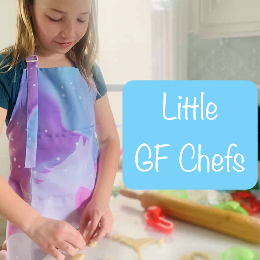 Miss E wearing a purple and aqua apron and focusing on cutting out cookie dough, cookie cutters and rolling pin scattered around counter, aqua text box with white text: Little GF Chefs