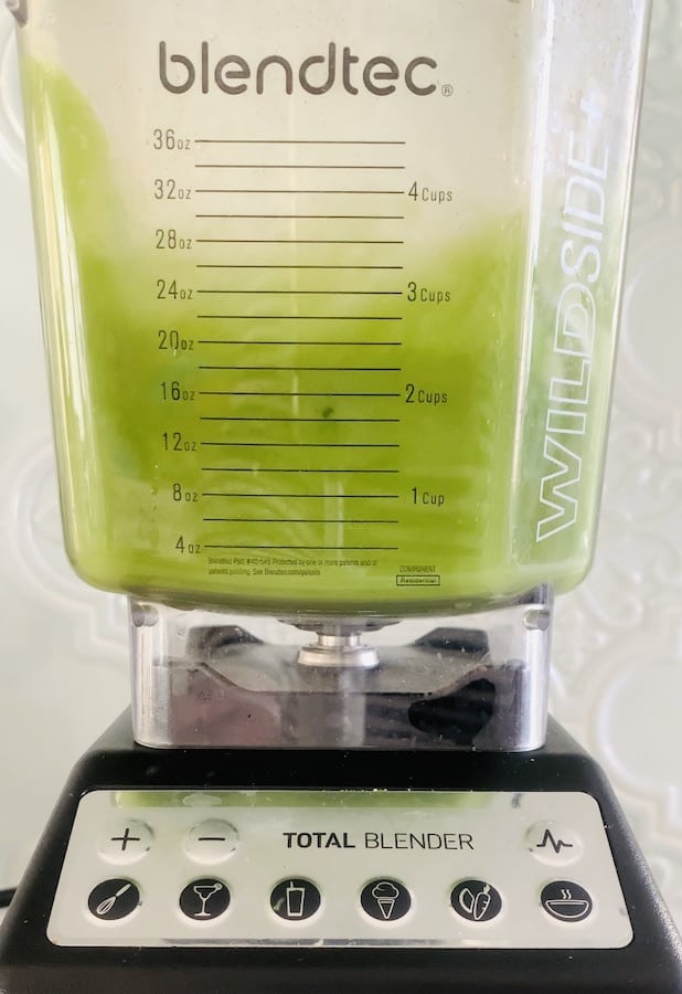 bright green matcha lemonade mixing in a blender