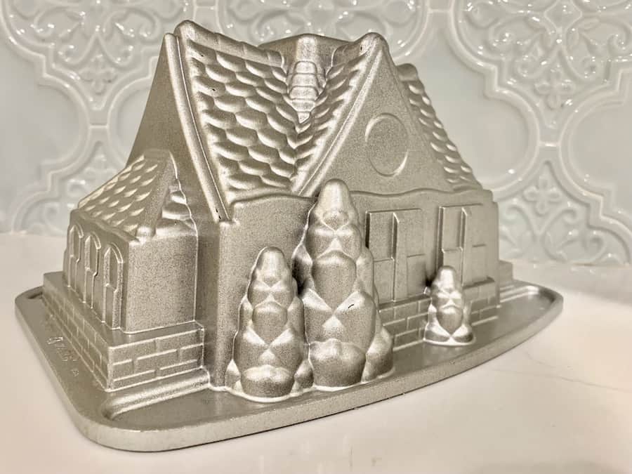 bund cake pan shaped like a house, with pine trees in front