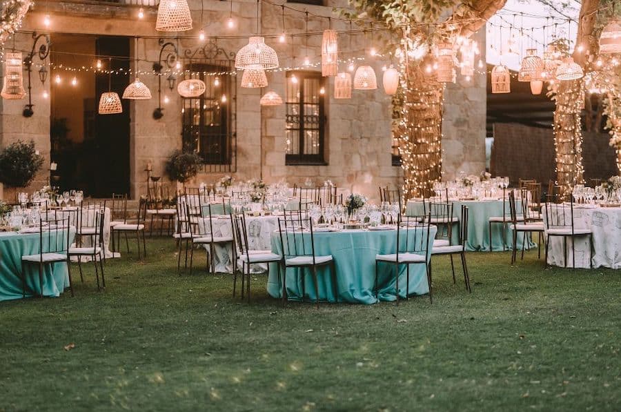 backyard wedding reception set up with hanging lights