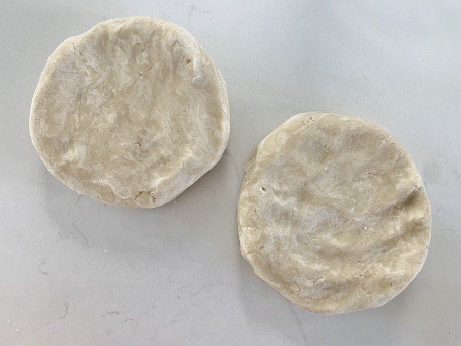 two pie dough disks, circles about 1" thick