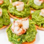 sweet potato slices topped with guacamole and one shrimp each