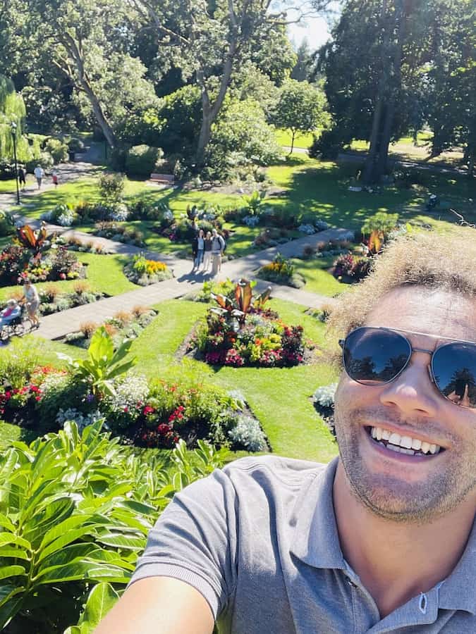 man with glasses taking selfie from up high, over garden