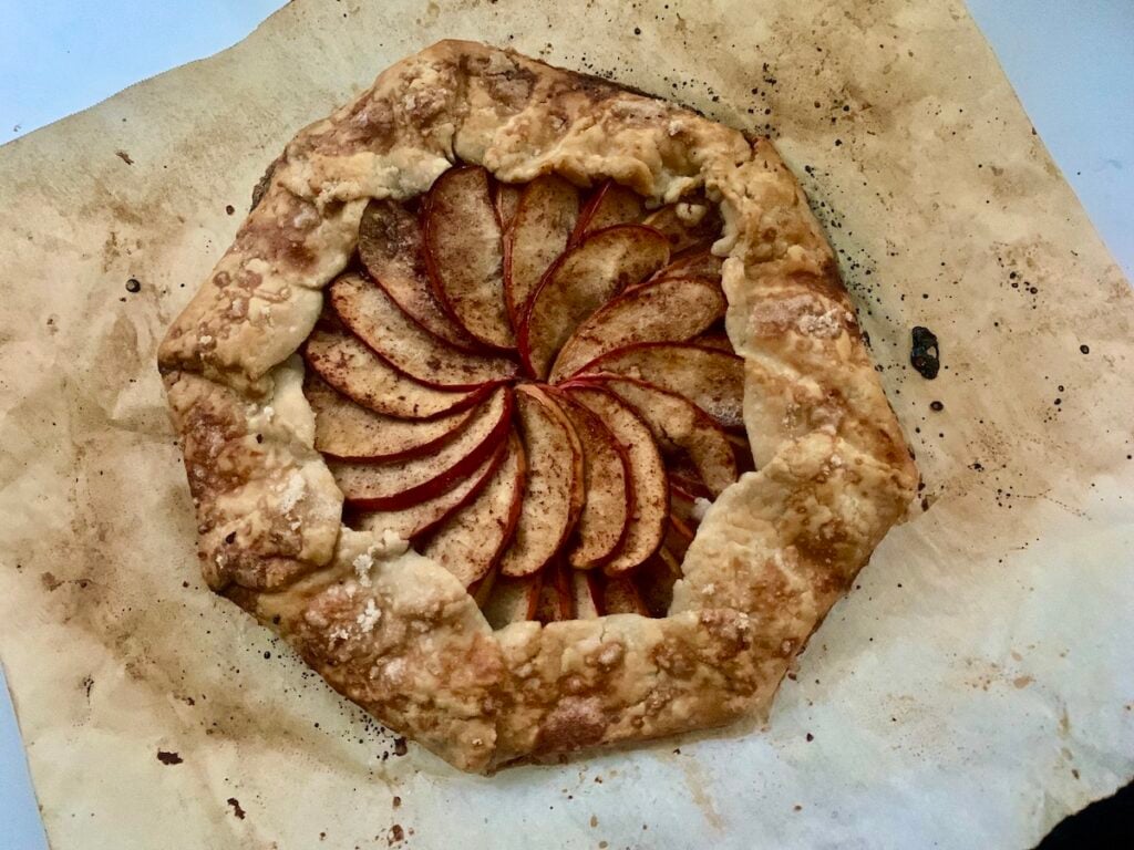 gluten-free apple galette on browned parchment paper