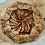 gluten-free apple galette on browned parchment paper