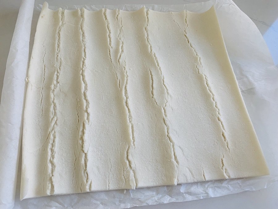 rolled out gluten-free puff pastry dough, visibly cracked