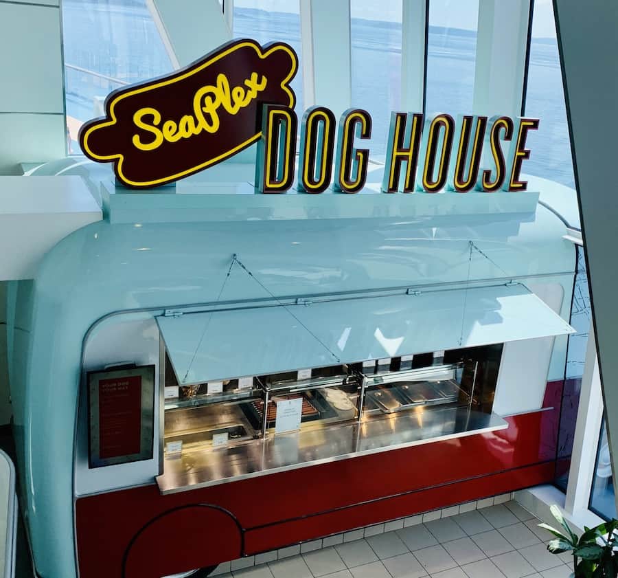 a hot dog stand with an airstream red/white food truck appearance, sign says "Seaplex Dog House"