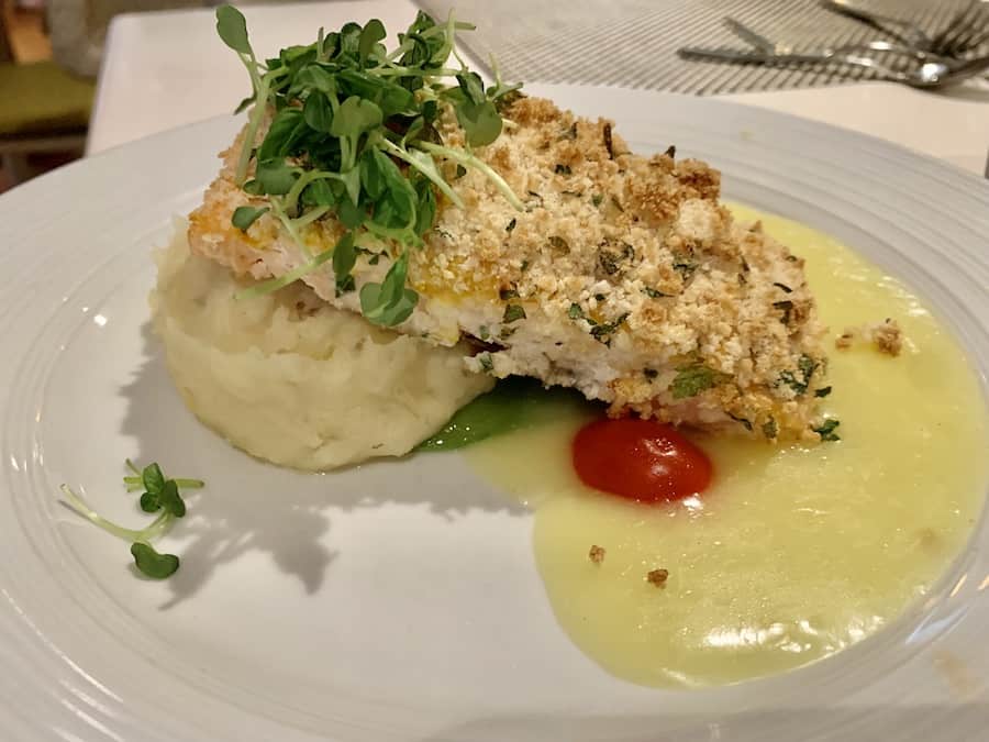 herb-crusted fish on mashed potatoes with a cream sauce