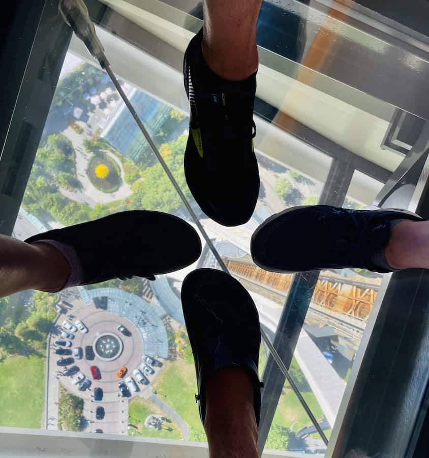 Four feet standing on the glass floor of the Space Needle