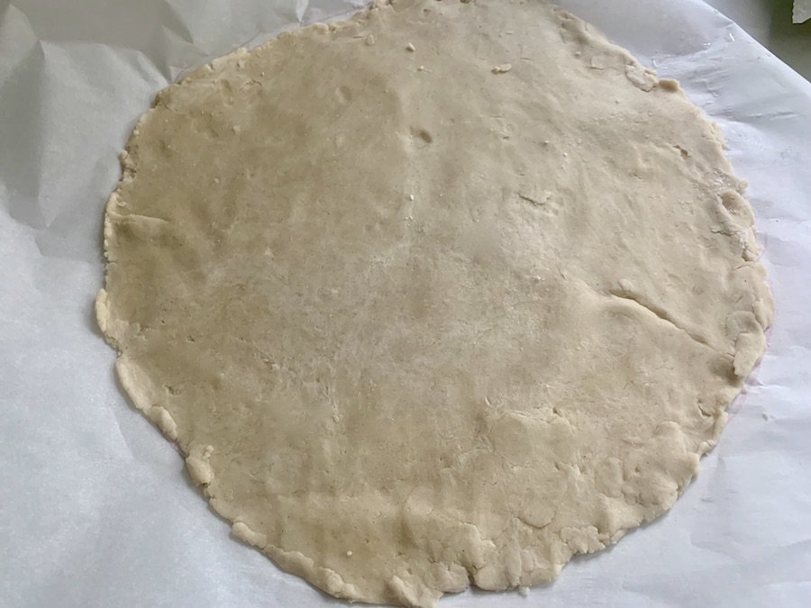a rolled out round of gluten-free pie dough