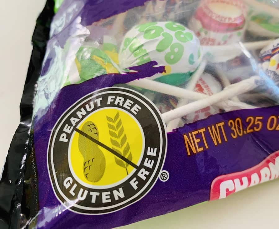 "Peanut Free, Gluten-Free" symbol with a photo of a peanut and piece of wheat crossed out, on a bag of candy.