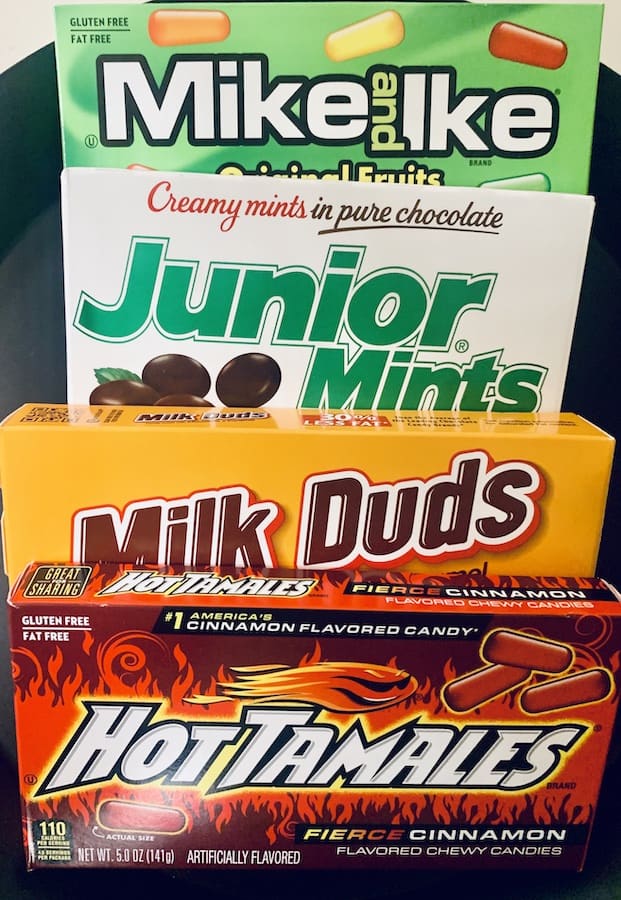 Boxes of Mike & Ikes, Junior Mints, Milk Duds, and Hot Tamales.