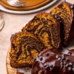 A sliced pumpkin chocolate bundt cake with visible swirls of chocolate and pumpkin.