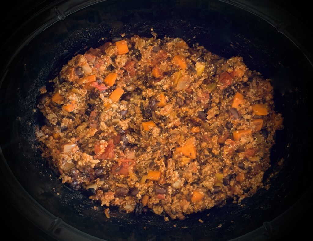 Birds eye view: chili in the bottom of an oval crockpot bowl.