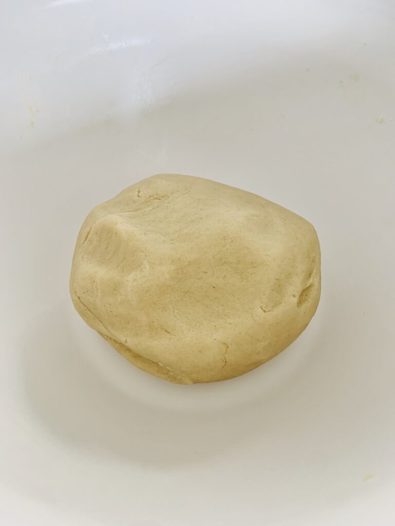 Ball of beige gluten-free dough.