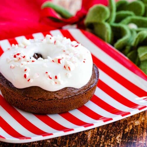 Baked chocolate donut topped with white icing and crushed candy canes.