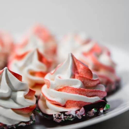 Red and white swirled meringues with chocolate on the bottom.