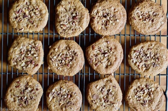 Birds eye view: pecan toffee cookies on a wire rack.