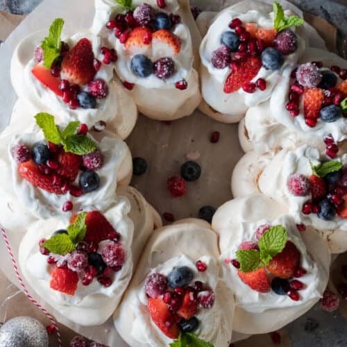 Bird's eye view: wreath-shaped pavlova topped with berries and mint.