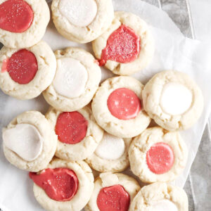 Bird's eye view: thumbprint cookies with red and white frosting in the center.