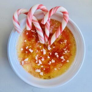 Birds eye view: candy cane creme brûlée topped with crushed candy canes and 3 mini candy canes.