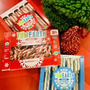 Boxes of YumEarth standard-size and mini peppermint candy canes, and standard size blue raspberry candy canes.