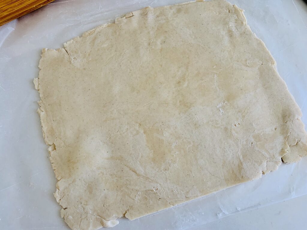 Pie dough rolled into a square.
