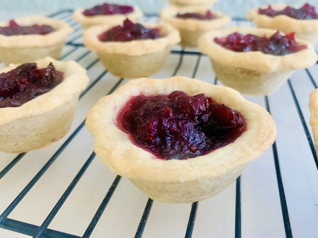 Gluten-Free Cranberry tarts on a wire rack.