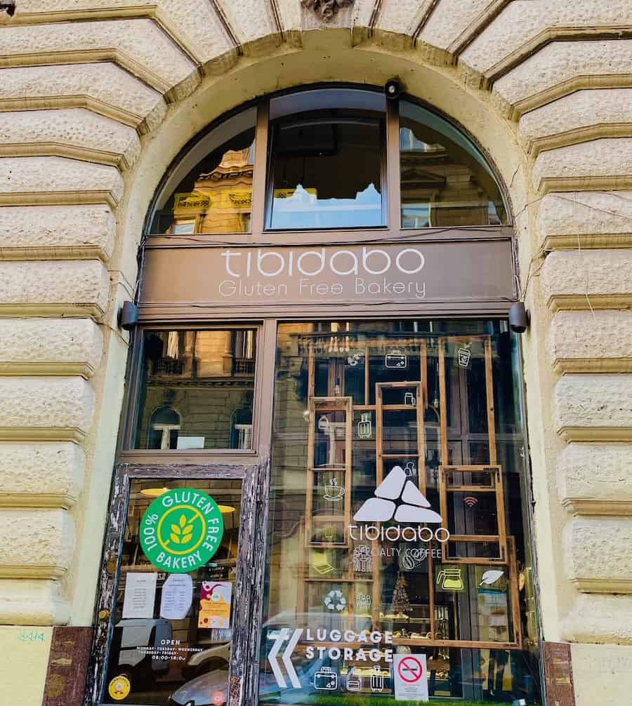 Outside view of bakery window with name on sign "Tibidabo gluten-free bakery".