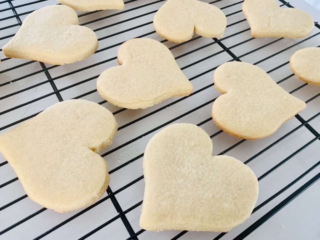 Heart cookies on a wire rack.