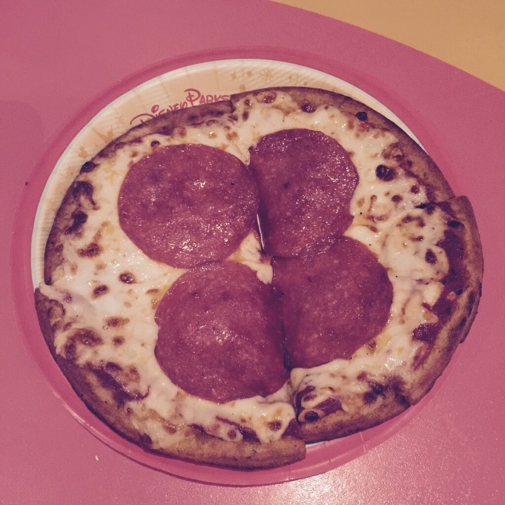 Small gluten-free pizza with four large slices of pepperoni.