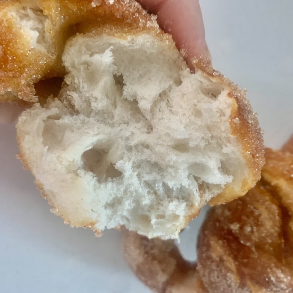 Soft, fluffy, white inside of a cinnamon sugar pretzel, very airy.