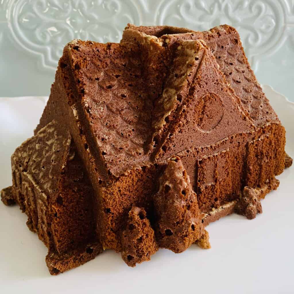 Undecorated gluten-free gingerbread house turned out on a counter.